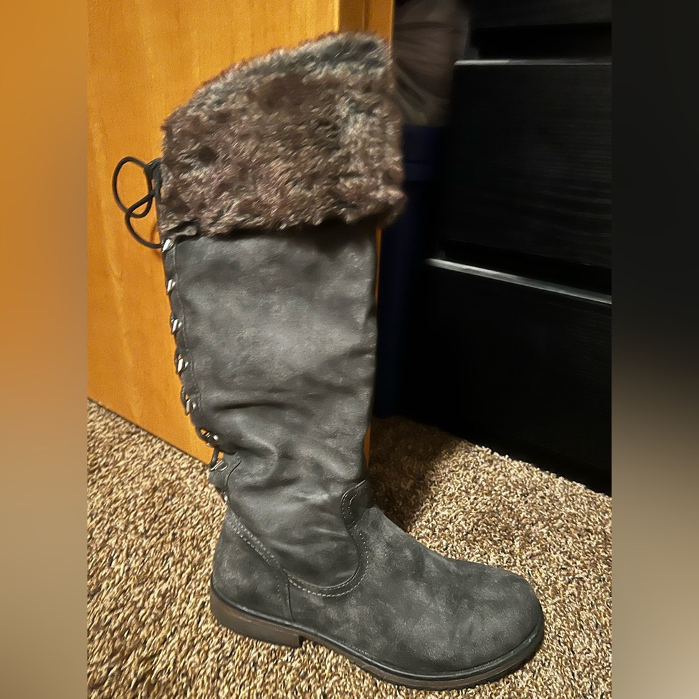 Knee high riding boots with faux fur. Lace up in back with side zipper.